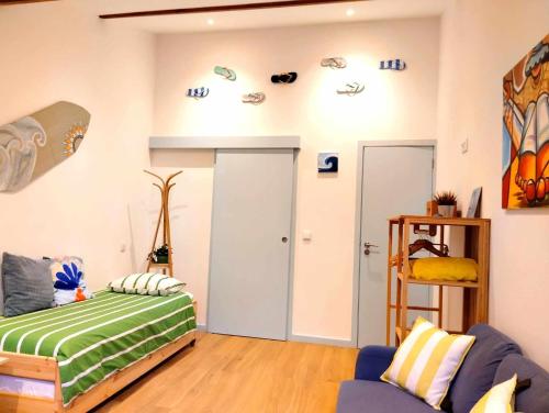 a room with a bed and a skateboard on the wall at Maria Surfista_ As Três Marias in Matosinhos
