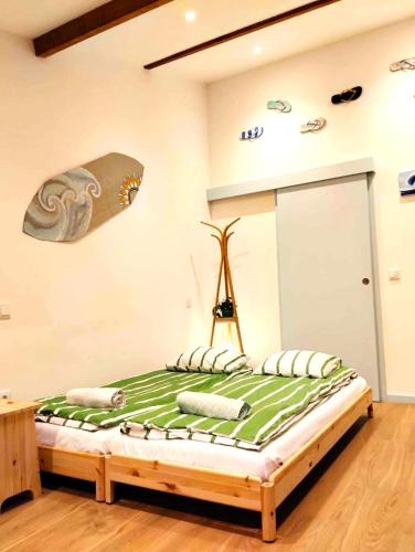 a bedroom with a bed with a surfboard on the wall at Maria Surfista_ As Três Marias in Matosinhos