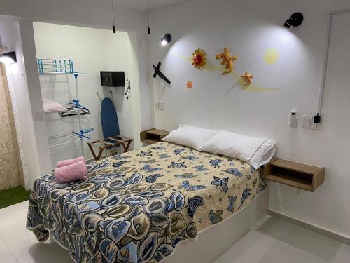 a bedroom with a bed with a patterned comforter at Porto Regina Suite in Cancún