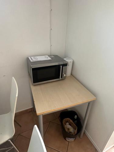 a microwave sitting on top of a table at Room A in Malmö