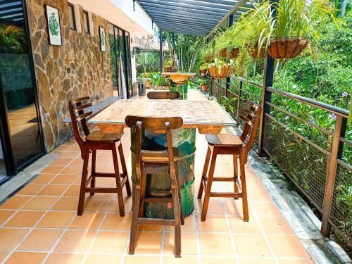 a wooden table and chairs on a balcony at Tierra Maravilla in Salento