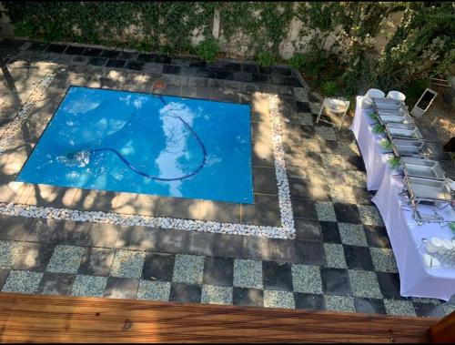 a swimming pool on a patio with a table and chairs at RRT Retreat Oasis in Pretoria