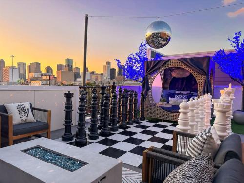 a chess board on a balcony with a view of a city at The Oasis Checkmate Stunning Rooftop with Views in Houston