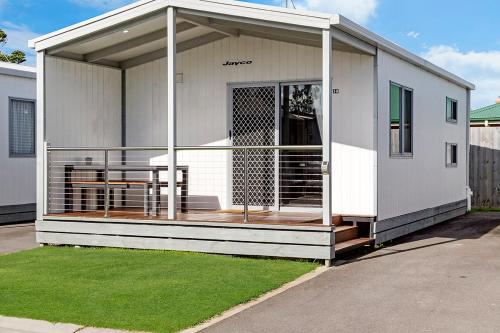 a house with a porch with a deck at Portland Holiday Village in Portland