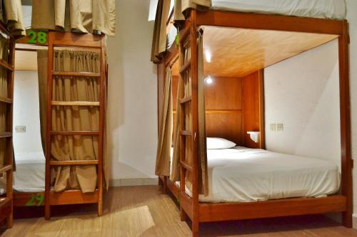 a room with two bunk beds and shelves at Hotel Petén Express in Flores