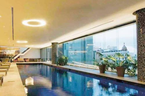 a swimming pool in a building with a large window at High-Rise Reforma Apartment , 2BDR, 2BATH, in Mexico City