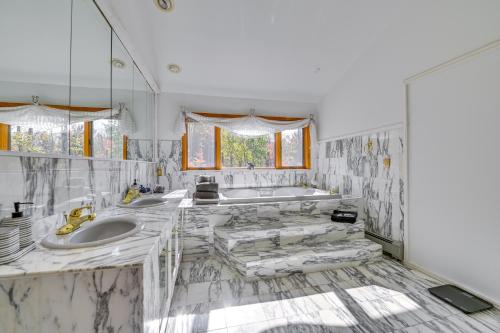 a white bathroom with two sinks and a tub at New York Retreat - Furnished Deck and Mountain Views in Lanesville