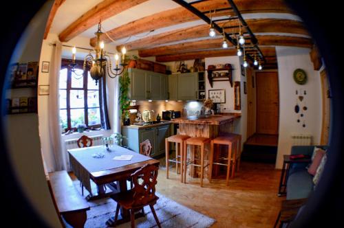 a kitchen with a table and a dining room at Chaud'Vin in Kaysersberg