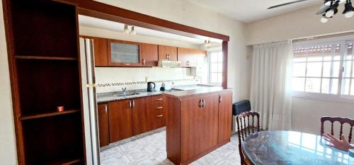 a kitchen with a table and a dining room at Atractivo in Rosario