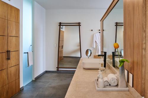 a bathroom with a sink and a mirror at Hotel Basalto in Punta Mita