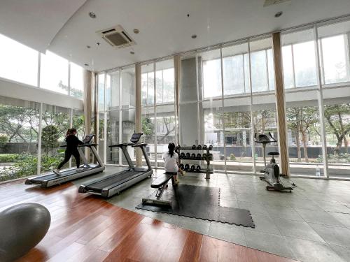 a gym with people exercising on treadmills in a building at Contemporary Comfort Sleek Studio Casa De Parco in Samporo