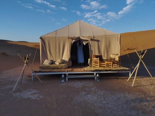 a tent in the middle of the desert at Saba Berber Travel in Mhamid