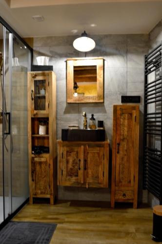 a bathroom with a sink and a mirror at Chaud'Vin in Kaysersberg