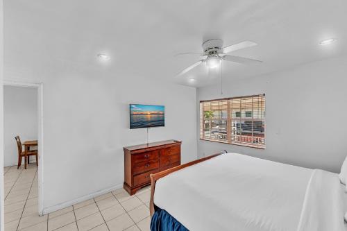 a bedroom with a bed and a ceiling fan at The Sunrise in Hollywood