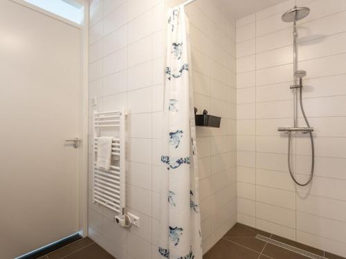 Un baño con ducha con cortina de ducha. en Apartment Kamperland near Harbour, en Kamperland
