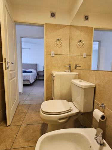 a bathroom with a white toilet and a sink at Dpto Centrico a dos Cuadras del Patio Olmos C/PILETA in Córdoba