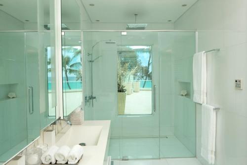 a bathroom with a shower and a sink and a mirror at FOOTPRINTS by DC in Saint James
