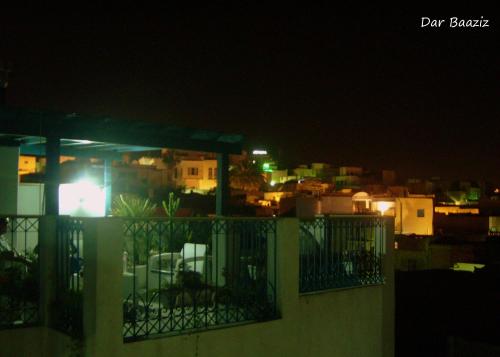 a view of a city at night from a balcony at Dar Baaziz in Sousse