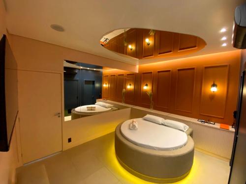 a bathroom with a round bed in the middle of it at Yolo Motel in Brasilia