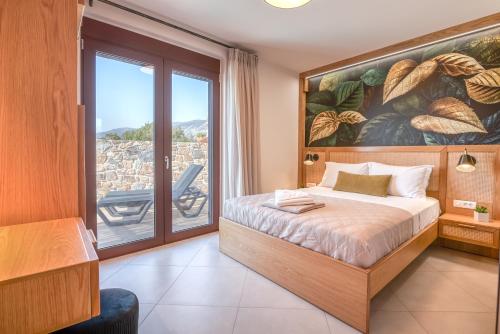 a bedroom with a bed with a large painting on the wall at Sia Elafonisi Pool House in Elafonisi