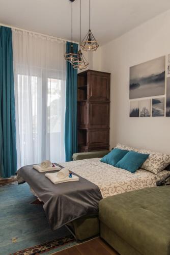 a bedroom with two beds and a large window at Balkan dream **** in Belgrade