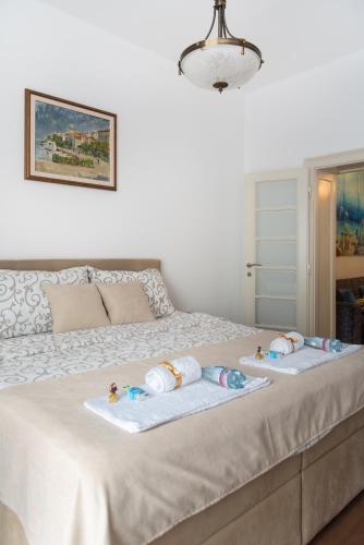a bed with two towels and two babies on it at Balkan dream **** in Belgrade