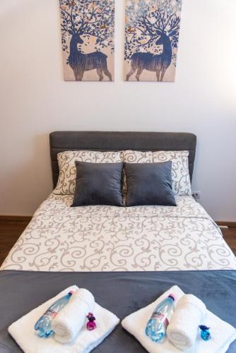a bedroom with a bed with towels on it at Balkan dream **** in Belgrade