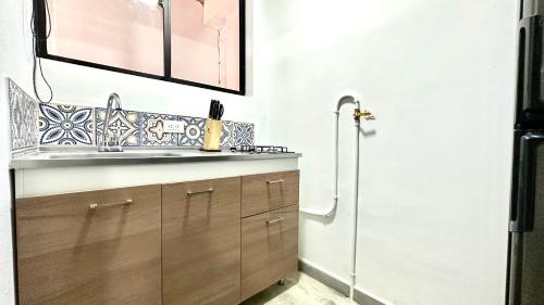 a bathroom with a sink and a shower at SINU LOFT in Medellín