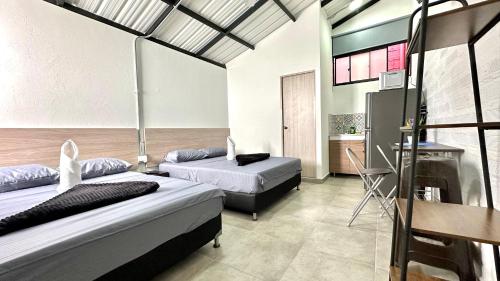a hotel room with two beds and a kitchen at SINU LOFT in Medellín