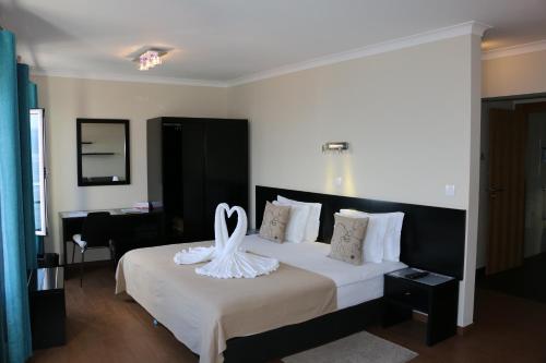 Ein Bett oder Betten in einem Zimmer der Unterkunft Apartamentos Kósmos