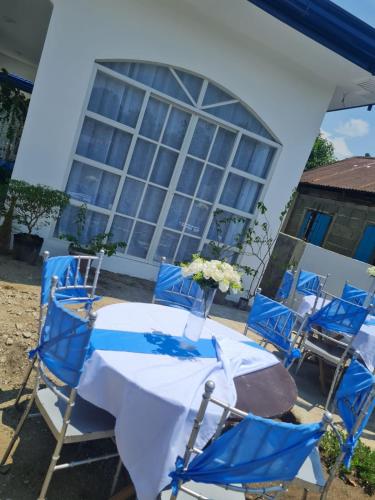 a table and chairs in front of a building at Palapag White House, your holiday home in Palapag
