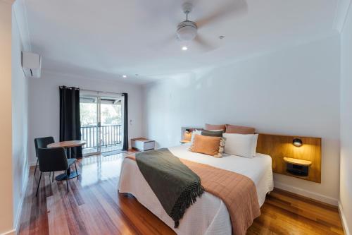 a bedroom with a large bed and a balcony at Eleven in Daylesford
