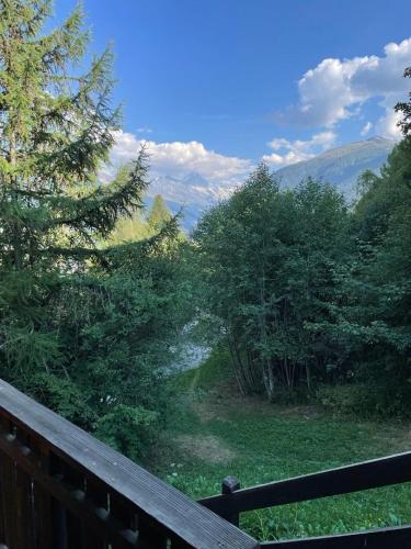 a view of a valley from a wooden fence at Chalet typique tout confort avec studio en dessous in Hérémence
