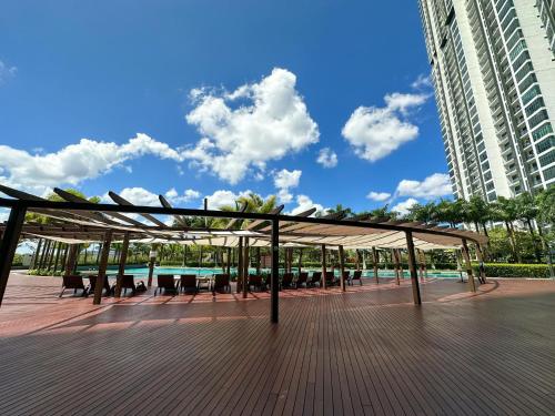 a pavilion with tables and chairs on a boardwalk at [Starry x DELUX] 8-10pax *free Netflix access in Masai
