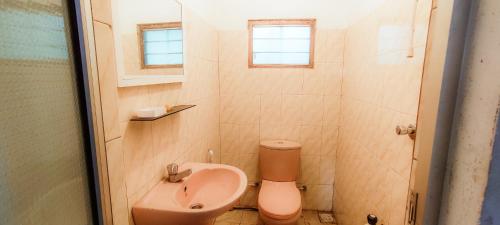 a small bathroom with a sink and a toilet at The Pearl Homestay in Nugatalawa