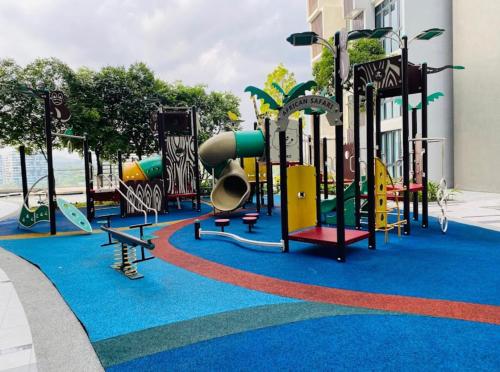 a playground with colorful equipment on a blue carpet at H20 Residence Ara Damansara Petaling Jaya in Petaling Jaya