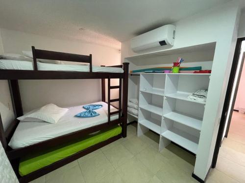 a small room with two bunk beds and a closet at Apartasol en Santa Fe de Antioquia in Santa Fe de Antioquia