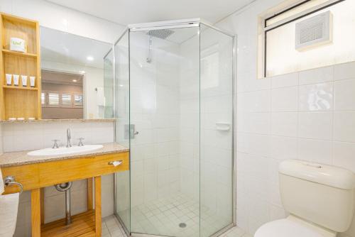 a bathroom with a shower and a toilet and a sink at Seahaven Resort in Townsville