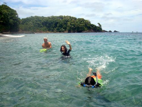two people and a dog swimming in the water at Hotel Panamonte in Boquete