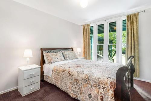 a bedroom with a bed and a window at Mirimvale - Base of Mt Buller - Sleeps 14 in Merrijig