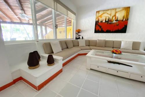 a living room with a couch and a coffee table at Villa en Playa Iguana, Ixtapa in Ixtapa