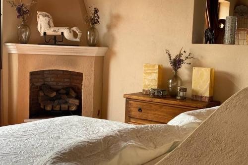 a bedroom with a bed and a fireplace at Casa Barranqueña in Guanajuato