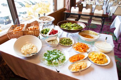 a table topped with bowls of different types of food at Kami no yama Azumaya in Kaminoyama