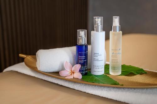 a tray with two bottles of soap and a towel at DoubleTree by Hilton Damai Laut in Lumut