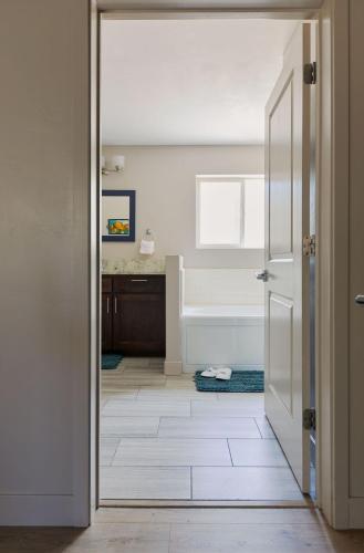 a bathroom with a door leading to a tub at Black Bear Lodge in South Lake Tahoe