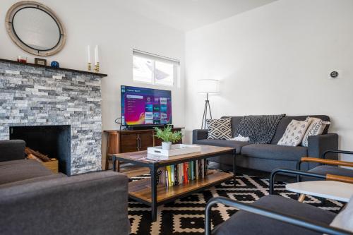 a living room with a couch and a fireplace at Big House Mins To DT Big Groups Well Stocked in Spokane