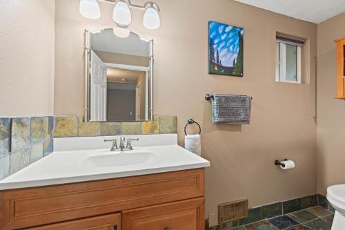 a bathroom with a sink and a mirror at Modern Amenities Gas Fireplace Central Location in Spokane