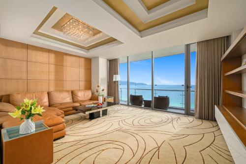 a living room with a couch and a table at Diamond Sea Hotel in Da Nang