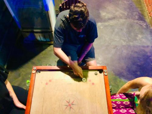 a man is standing next to a wooden box at Little Folly in Ella