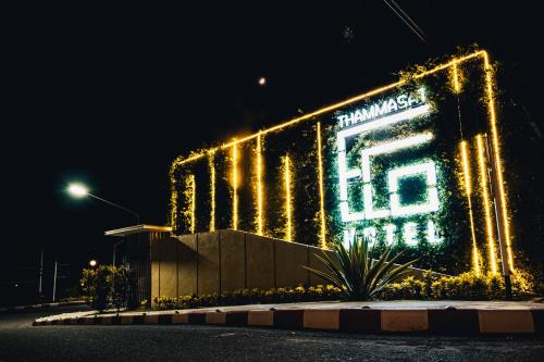 a building with lights on it at night at Eco Hotel by Thammasat in Bang Lamung